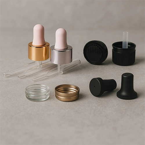 Redex Glass dropper caps, lids, and accessories in various materials and finishes, displayed on a neutral background.