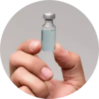 Hand holding a Redex Glass vial, emphasizing product quality and precision craftsmanship.